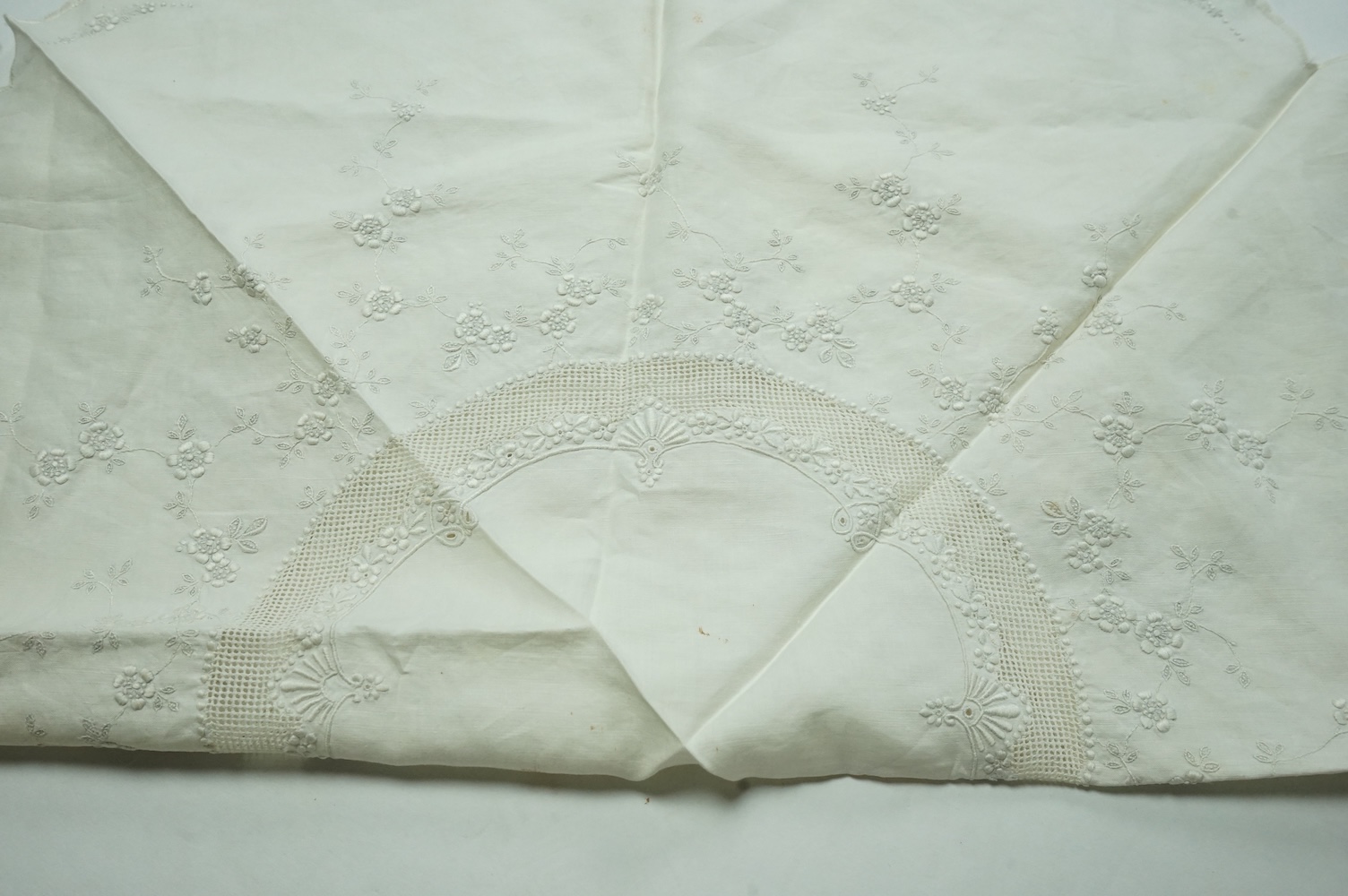 An unusual Victorian white linen hand worked table cloth. Embroidered along one edge, Wrought by L. Grover for her daughter Ethel Frances Burbury 1895. Together with three crochet edged cloths and a circular embroidered